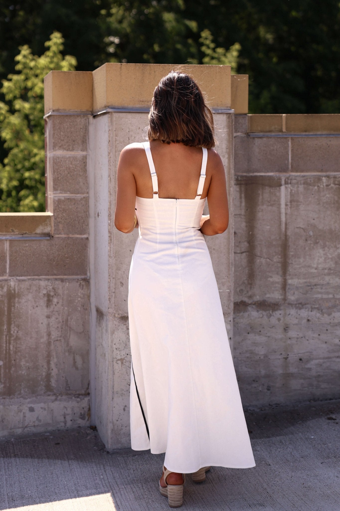 Back detail of white maxi dress with black trim